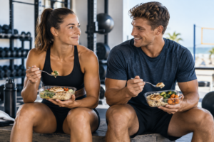 Male and female athletes eating balanced meals after training to support performance and body composition goals